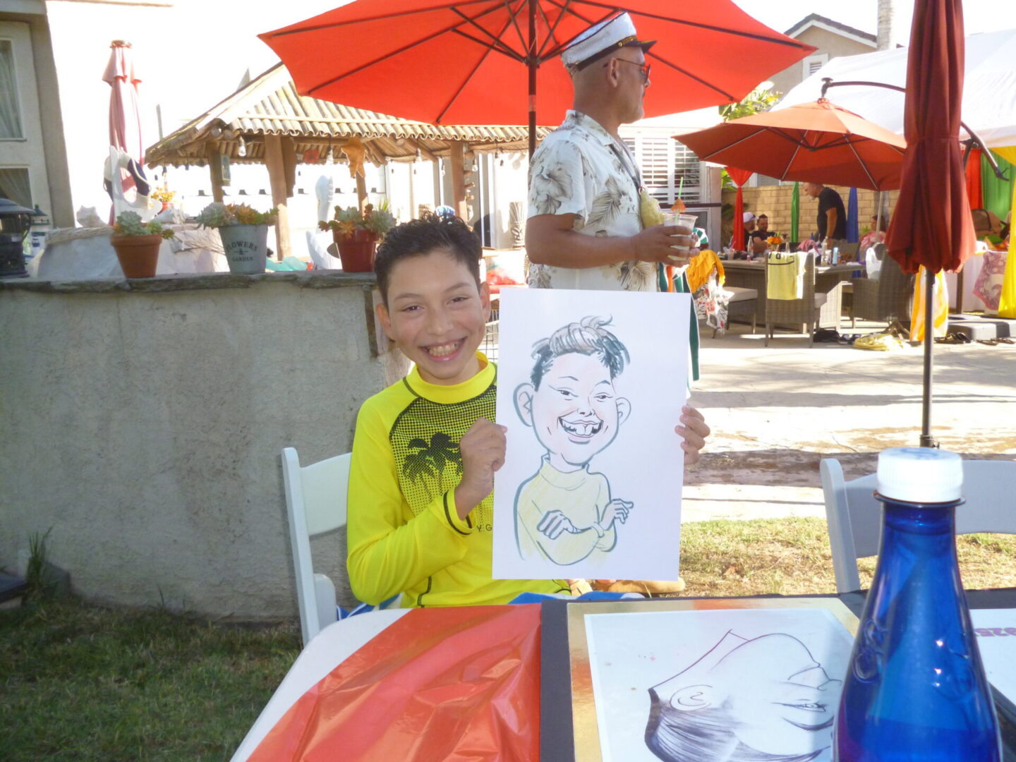 Boy holding caricature drawing outdoors