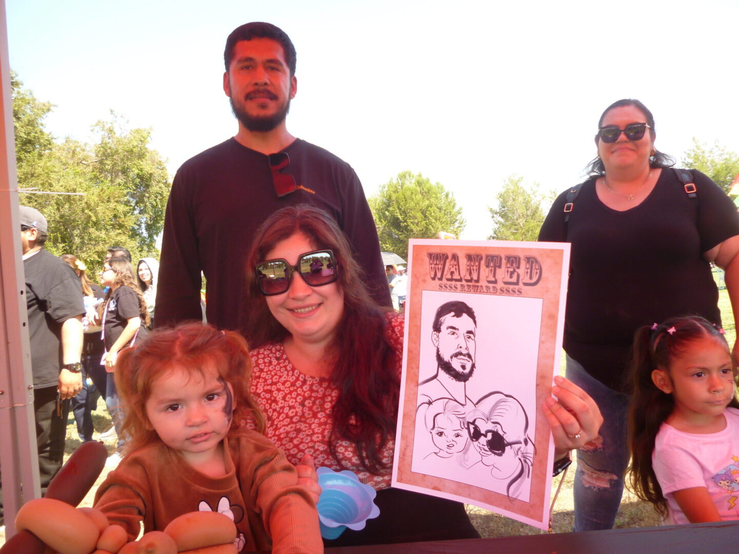 Group posing with wanted poster