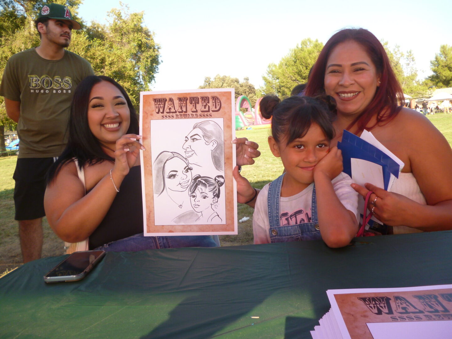 Family smiling with caricature drawing