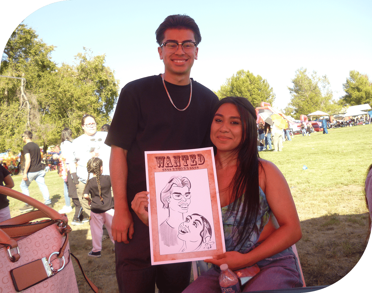 Smiling pair with cartoon drawing outdoors